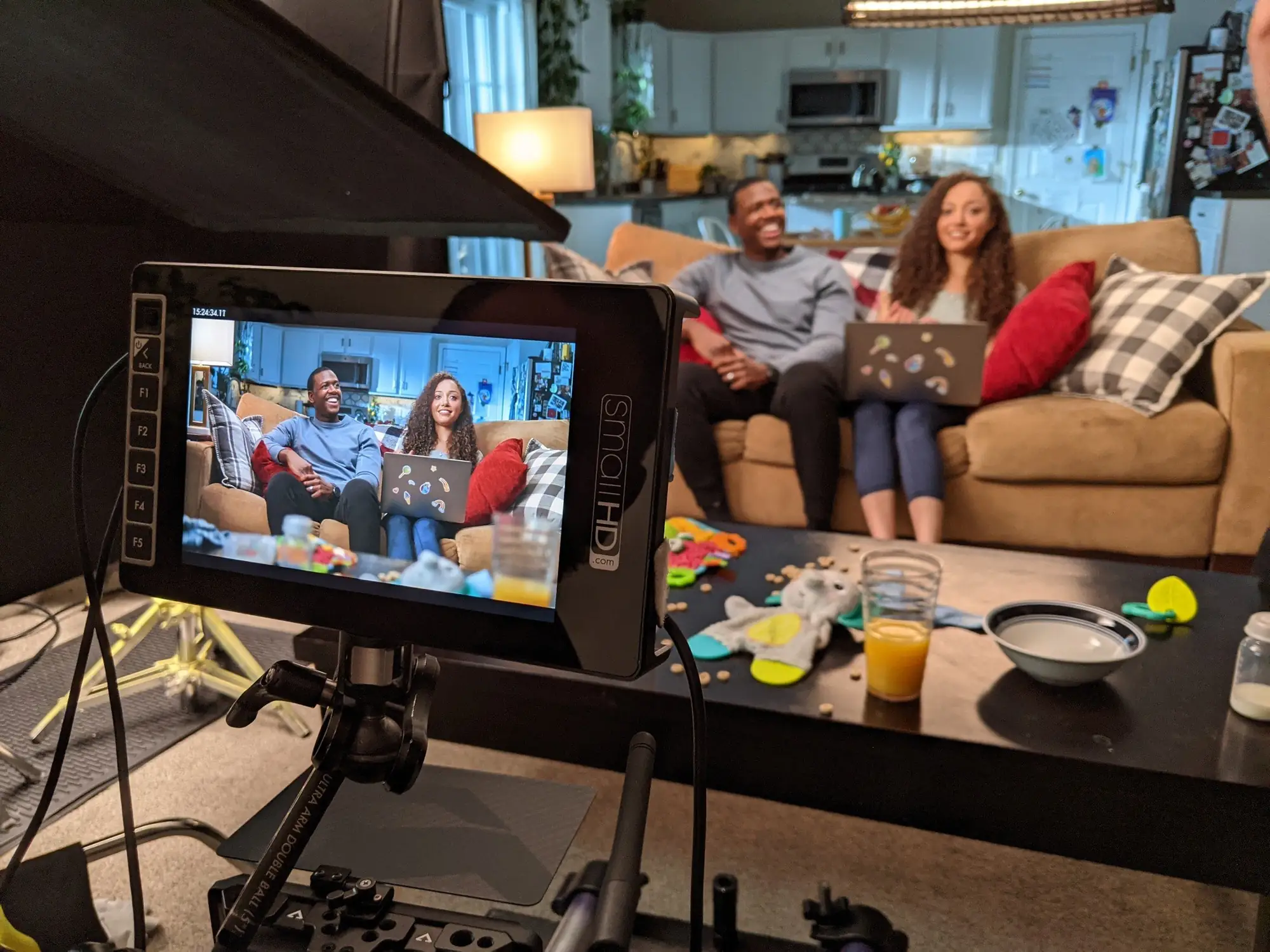 Monitor showing the family scene being filmed in a living room