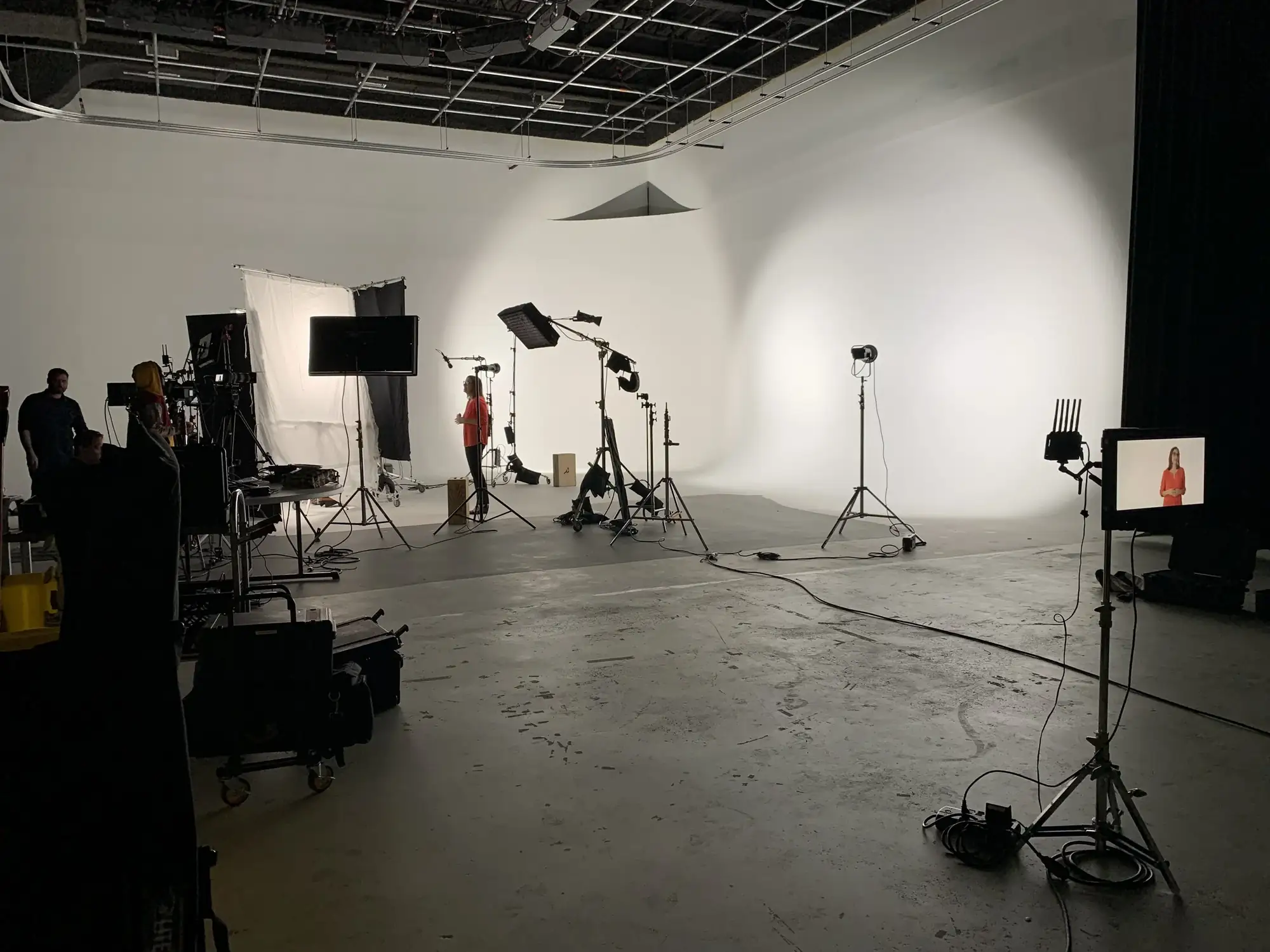 Wide view of a white studio set up for an interview