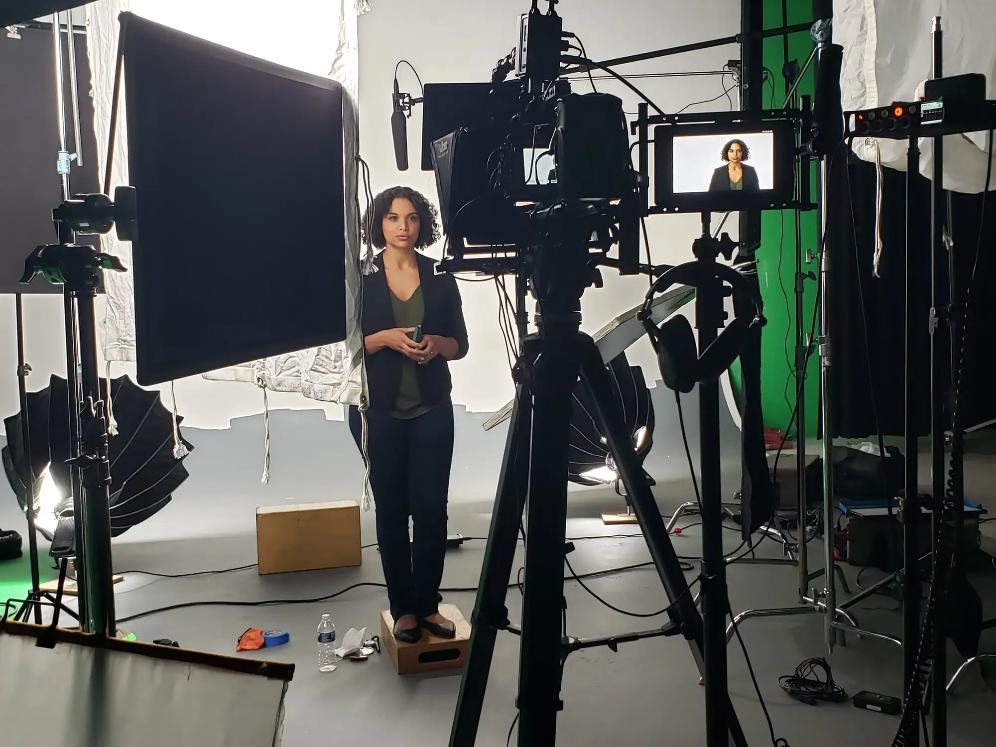 Woman standing for interview shoot in front of green screen
