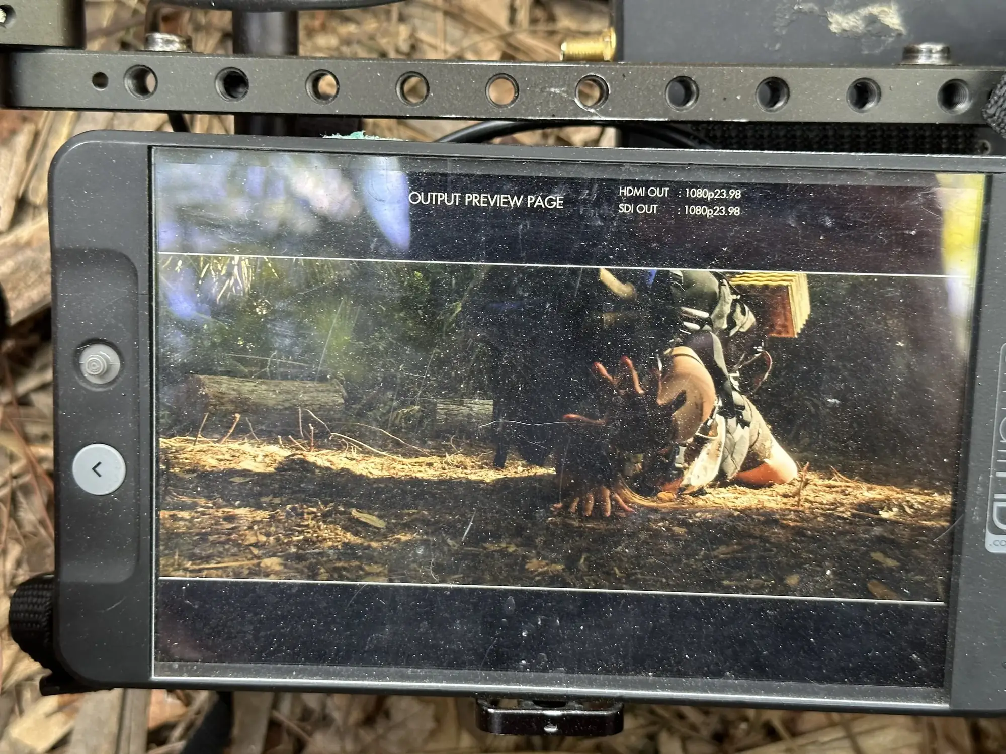 On-camera monitor showing an actor on the forest floor