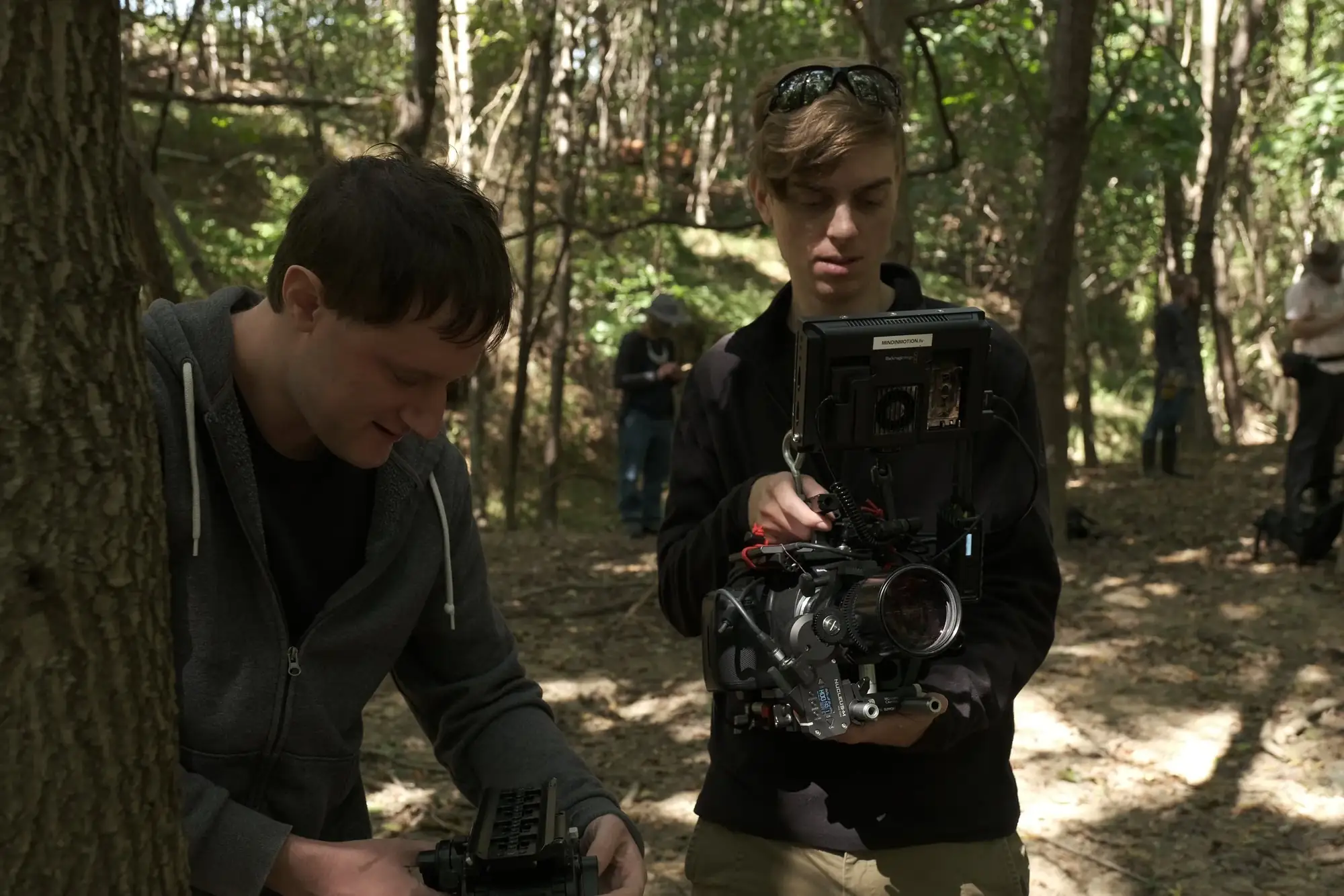 Camera operator and crew member in the woods between takes