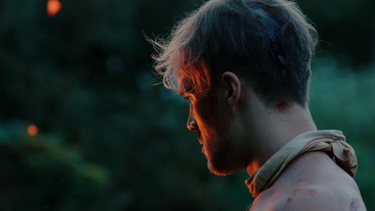 Bad Witch feature film — profile of a bloodied young man at dusk